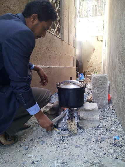 Ameen cooking with wood